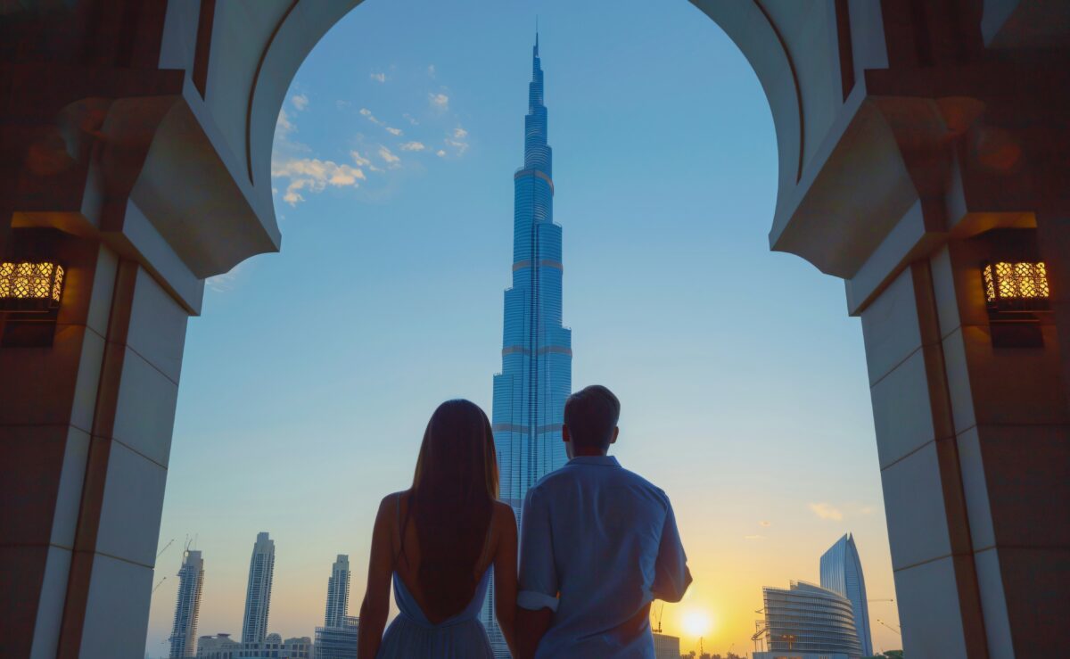 Couple looking at the Burj Khalifa.This is the concept image for a blog titled "Do I need a visa to transit through Dubai?"
